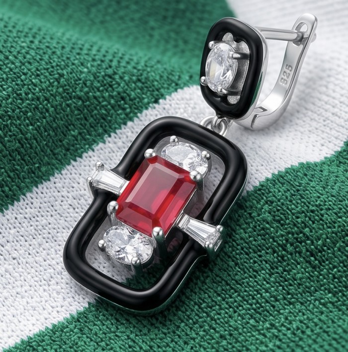 Art Deco - 4.5 carat Ruby enamel .925 Sterling Silver handcrafted incredible earrings - Close-up of Art Deco ruby enamel earring on green fabric background.