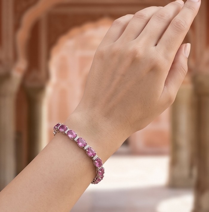 Luxurious 45.4 carat Pink Sapphire rhodium over .925 Sterling Silver handcrafted Bracelet - Pink sapphire bracelet worn on hand, front view.