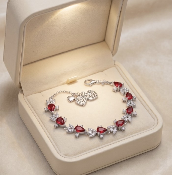 Crimson Fire 5.2 carat Ruby .925 Sterling Silver .925 Sterling Silver Statement Bracelet - Bracelet in box, top view, showcasing red rubies and heart charms.