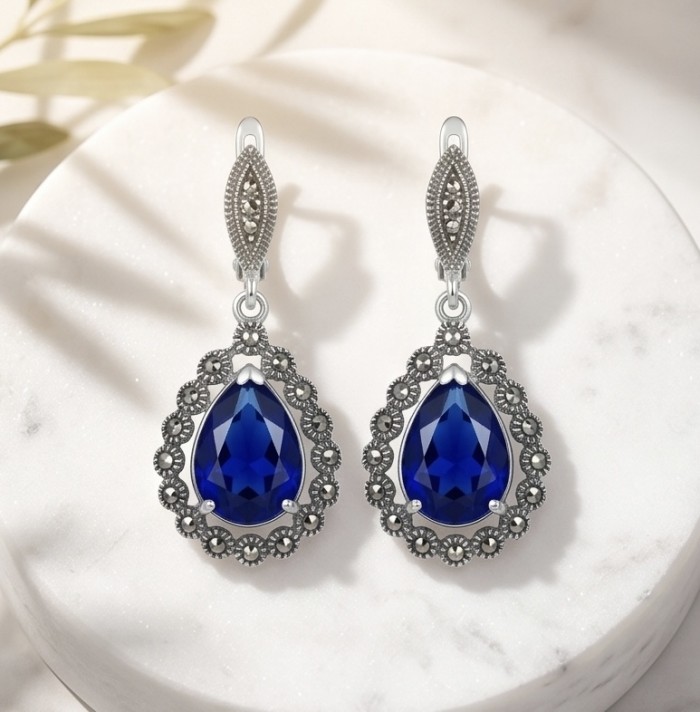 Julietta 15.5 carat London Blue Topaz Marcasite .925 Sterling Silver handmade Statement earrings - Front view of Julietta blue topaz and marcasite earrings on display.