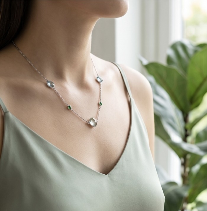 Infinity 8.5 carat Authentic Multigems Rhodium over .925 Sterling Silver handcrafted Statement necklace - Necklace worn, showcasing multi-gem design against a green top.