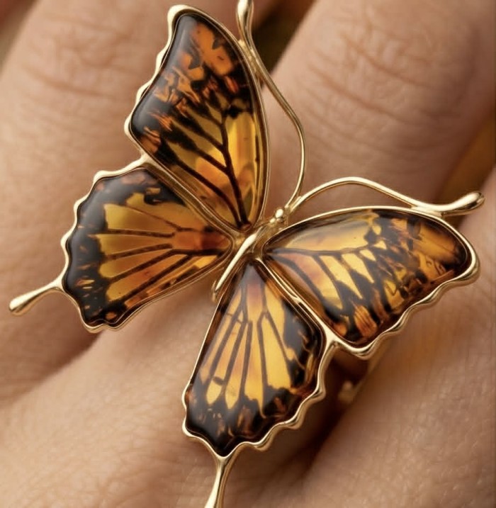 Golden Butterfly Authentic Baltic Amber .925 Sterling Silver dipped in 22K Gold handcrafted ring; s. 7 adjustable - Butterfly amber ring worn on hand, close-up detail.