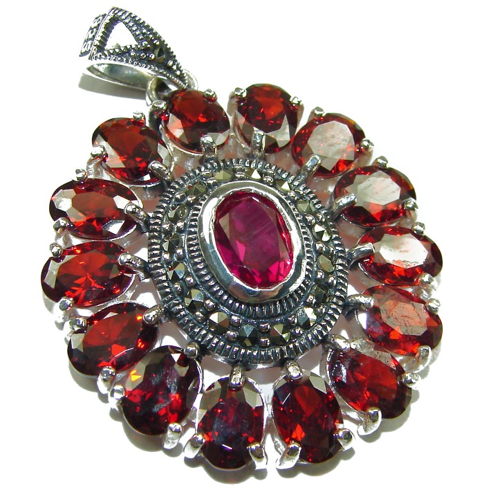 Marvelous Natural 20.8 carat Mozambique Garnet .925 Sterling Silver Handcrafted pendant - Close-up of sterling silver pendant with red garnets and central stone.