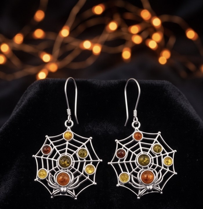 Spider's Web - Authentic Baltic Amber .925 Sterling Silver handcrafted earrings - Spider web earrings with amber stones on black velvet, frontal view.
