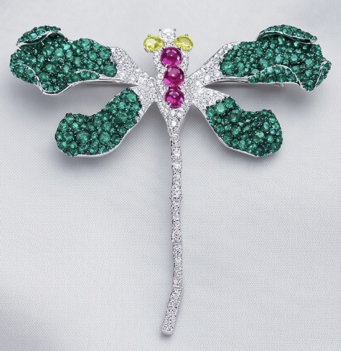 Precious Dragonfly 9.2 carat pave Colombian Emerald rhodium over .925 Sterling Silver handcrafted Brooch Pendant - Dragonfly brooch with emeralds and jewels, top view on fabric.
