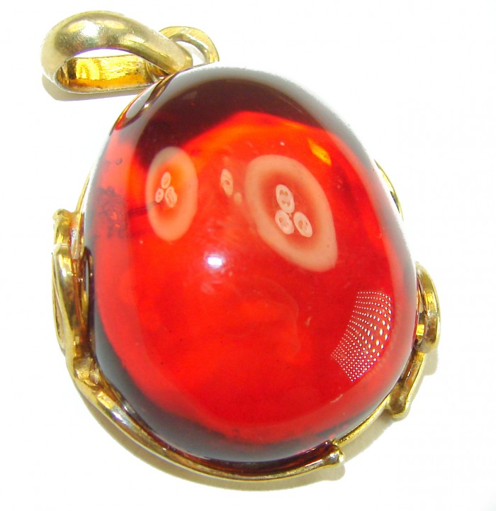 Prehistoric Authentic Baltic Amber .925 Sterling Silver dippedin 14K Gold beautifully handcrafted Pendant - Close-up of red amber pendant with gold-toned bail
