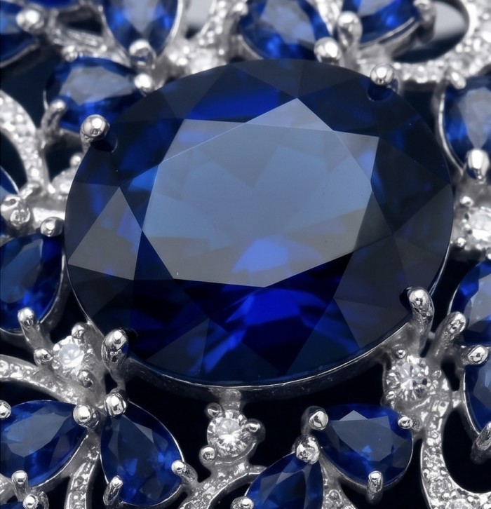 An exuberantly Large 135.8 carats Vintage style Sapphire .925 Sterling Silver DIPPED IN RHODIUM handmade LARGE Pendant - Brooch - Close-up of a large vintage-style sapphire surrounded by diamonds.
