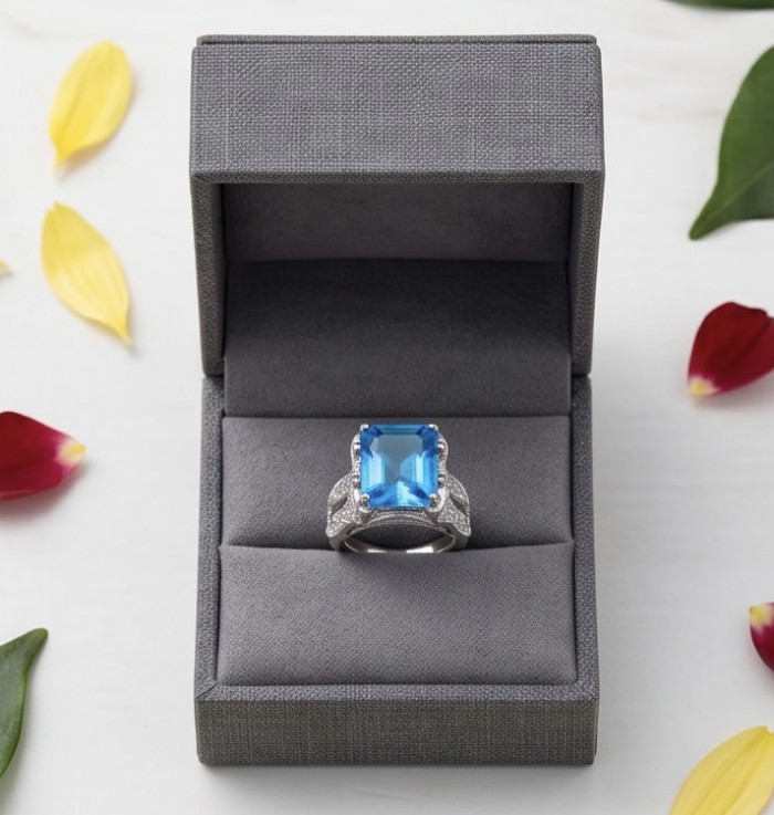 Blue OCEAN 14.3 carat Swiss Blue Topaz .925 Sterling Silver dipped in rhodium handcrafted ring size 7 1/4 - Blue topaz ring in open box, top view, with petal accents