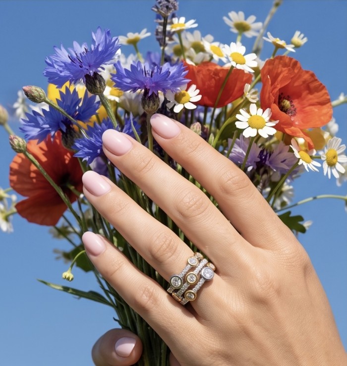 Aphrodite - 1.8 carat White Topaz two tones .925 Sterling Silver handcrafted ring size 7 3/4 - Hand wearing Aphrodite ring holding colorful flowers against blue sky