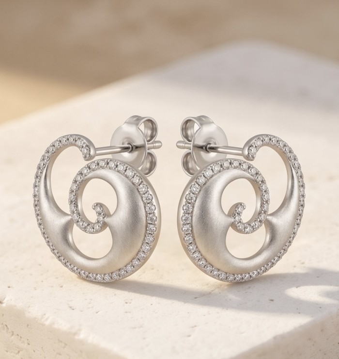 Waves 0.6 carat authentic White Topaz .925 Sterling Silver Handcrafted Earrings - Elegant swirl earrings with white topaz, side view on stone surface.