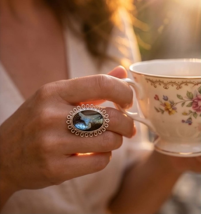 Australian Boulder Opal .925 Sterling Silver handcrafted Large ring size 7 1/4 - Boulder Opal ring worn on hand holding floral teacup in sunlight.
