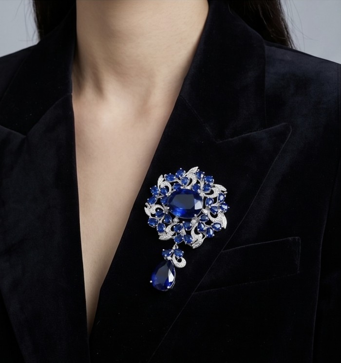 An exuberantly Large 135.8 carats Vintage style Sapphire .925 Sterling Silver DIPPED IN RHODIUM handmade LARGE Pendant - Brooch - Sapphire brooch worn on blazer, showcasing detailed design.