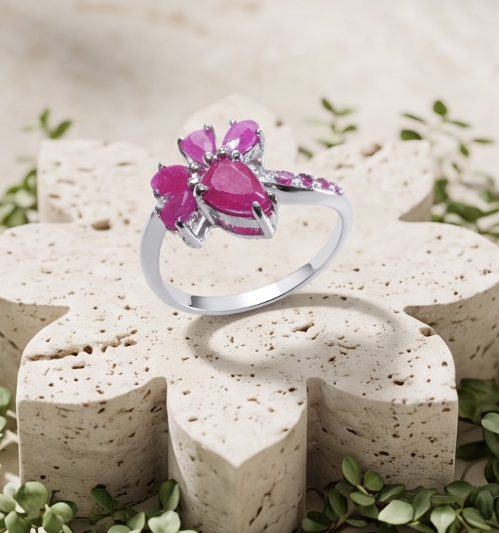Blooming Garden 3.8 carat Mozambique Ruby rhodium over .925 Sterling Silver handmade Statement Ring size 9 - Mozambique Ruby ring on stone floral display, front angle view.