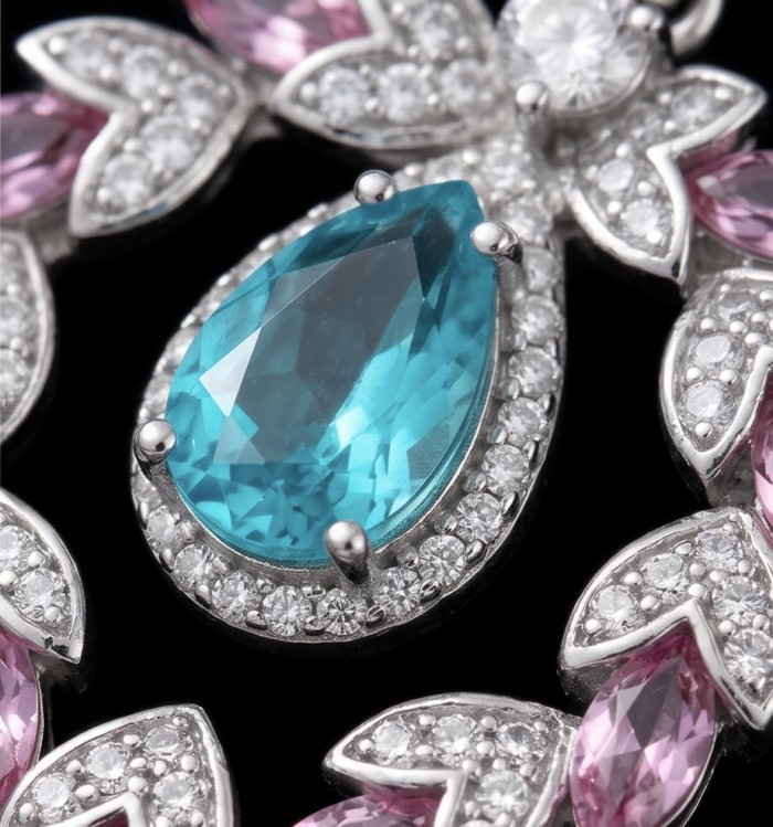 Bellissima Incredible 12.5 carat Paraiba Tourmaline .925 Sterling Silver entirely handmade earrings - Close-up of 12.5 carat Paraiba Tourmaline with pink and white accents.