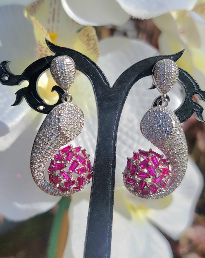 Pure Luxury 22.2 carat natural Ruby .925 Sterling Silver handmade Statement earrings - Close-up of ornate ruby and silver drop earrings on display.