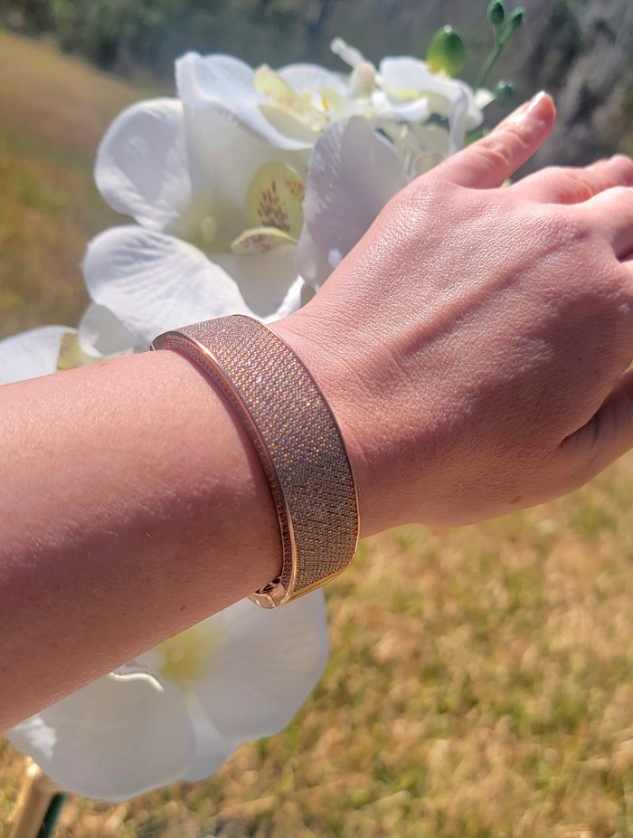 Tiffany Genuine 36.5 carat White Topaz Rose Gold over .925 Sterling Silver handcrafted Statement bracelet - Bracelet worn on wrist near white flowers in outdoor setting.